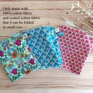 May include: Three small, patterned pouches in shades of teal, red, and floral print. The pouches are made of 100% cotton fabric and coated cotton fabric. The text on the image says the pouches can be folded to a small size.