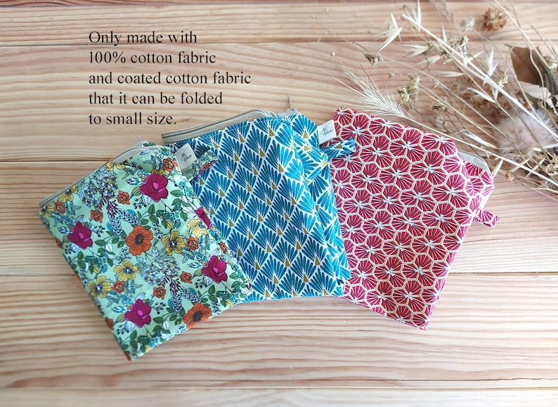 May include: Three small, patterned pouches in shades of teal, red, and floral print. The pouches are made of 100% cotton fabric and coated cotton fabric. The text on the image says the pouches can be folded to a small size.