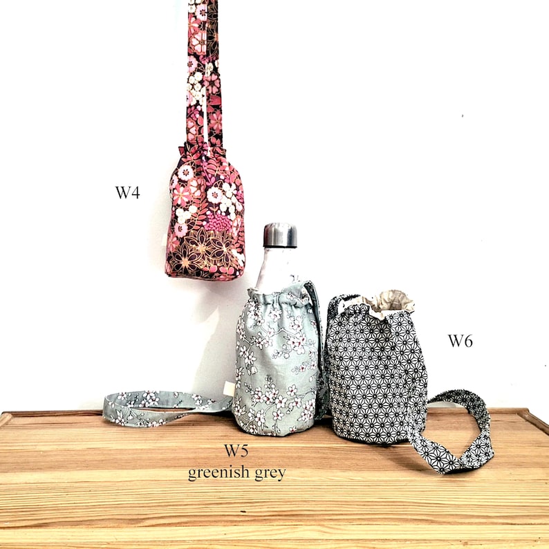 May include: Floral fabric water bottle carriers in pink, greenish grey, and black and white patterns. The carriers have drawstring closures and straps. The text "W4", "W5 greenish grey", and "W6" are visible.