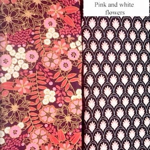 May include: Two vertical fabric swatches. The left swatch features a dark maroon background with pink and white floral patterns and the text "Pink floral". The right swatch displays a black background with a repeating pink and white petal pattern and the text "Floral drops" and "Color Pink and white flowers".