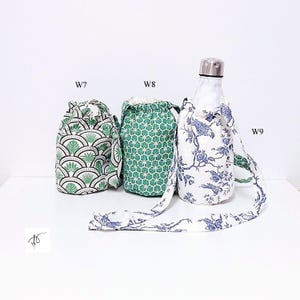 May include: Three fabric water bottle holders with drawstring closures. One features a green and white fan leaf pattern, another has a green geometric design, and the third has a blue floral print. The bottle holder with the floral print has a matching strap.