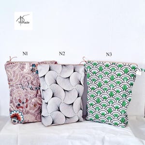 May include: Three zippered pouches with different patterns. The first pouch has a floral design in shades of pink, red, and blue. The second pouch has a black and white fan-like pattern. The third pouch has a green and white geometric design. The pouches are labeled N1, N2, and N3.