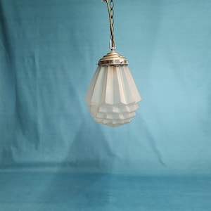 An opaque art deco pendant light