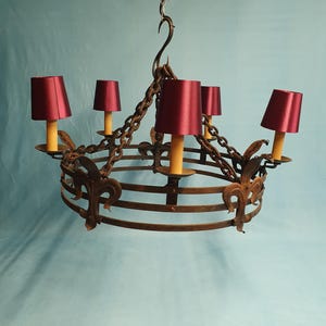 Large steel chandeliers with decorative fleur de lis decoration