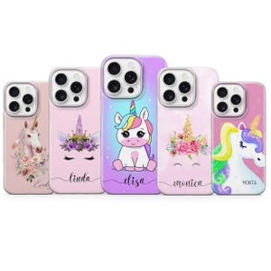 May include: A collection of five phone cases featuring unicorn designs. Each case has a different design, including a unicorn head with floral accents, a cartoon unicorn, and a unicorn with a rainbow mane. The cases are in shades of pink, purple, and white.