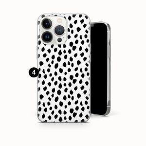 May include: A clear phone case with a black and white dalmatian spot pattern. The case is shown with a black smartphone. The phone case has a camera cutout and button covers.