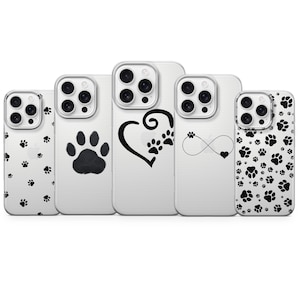 May include: A collection of clear phone cases with various paw print designs. The cases feature black paw prints, a paw print heart, and an infinity symbol with a heart. The cases are designed for a smartphone.