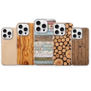 May include: Five smartphone cases arranged in a row, each featuring a distinct pattern: light beige wood grain, dark brown wood grain, horizontal pastel planks with floral accents, a cross-section of stacked logs, and vertical dark wood with a small heart.