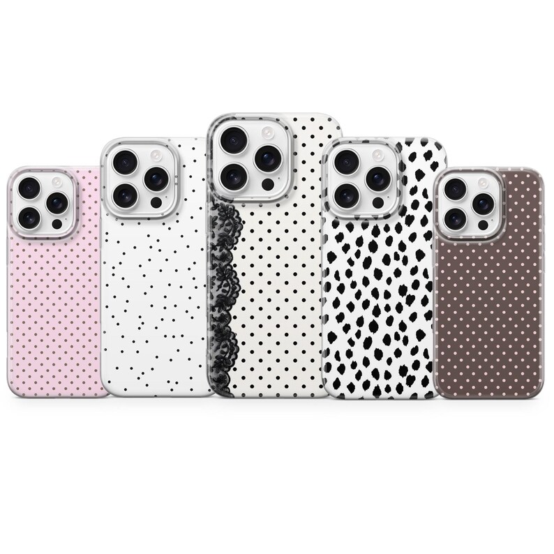 May include: A collection of five phone cases with various patterns. The cases feature designs including polka dots, a lace border, and abstract black shapes on white backgrounds. One case is light pink with white dots, and another is brown with white dots.