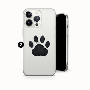 May include: Clear phone case with a black paw print design. The case is shown with a black smartphone. The paw print is centered on the back of the case.
