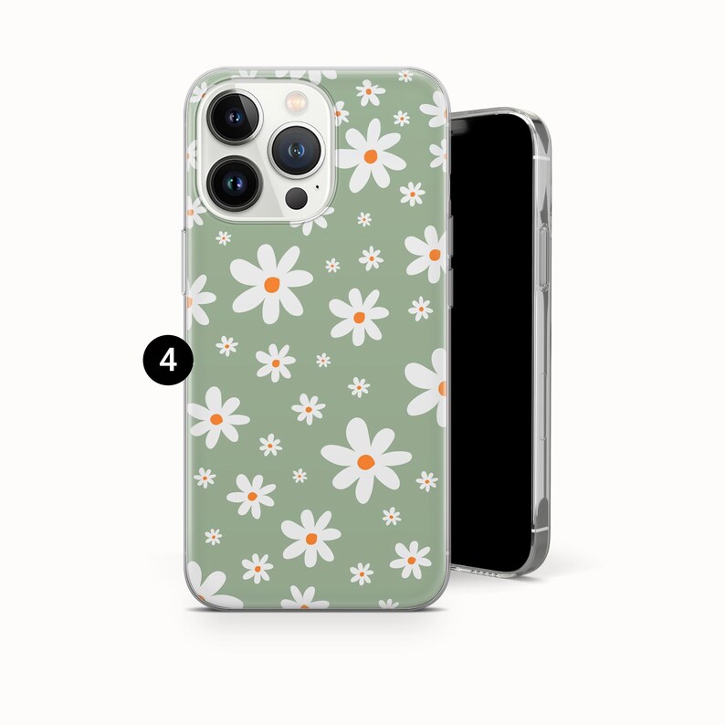 Pode incluir: Uma capa de telefone com um padr&atilde;o floral de margaridas. A capa tem um fundo verde claro com margaridas brancas e laranja. A capa do telefone est&aacute; em um fundo branco.