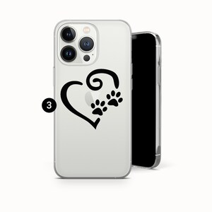 May include: Clear phone case featuring a black heart design with paw prints. The case is made of a transparent material, allowing the phone's color to show through. The design is simple and elegant.