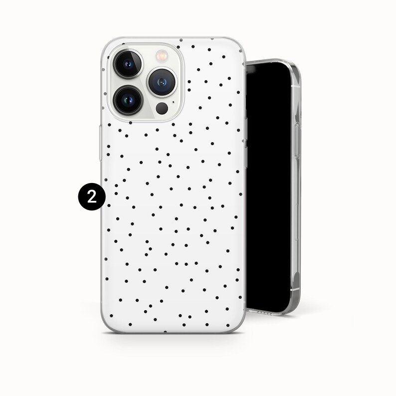 May include: A white phone case with a black polka dot pattern. The case is shown with a black smartphone. The phone case has a clear, protective design.