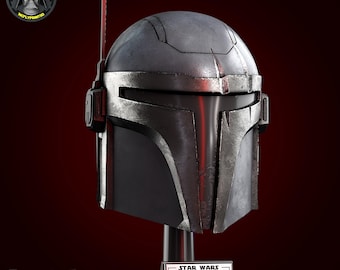 May include: A Mandalorian helmet replica, mainly grey with silver detailing, presented on a black stand. The helmet has a visor and an antenna-like feature. The base reads "STAR WARS MANDALORIAN HONOR" and the Fortnite logo is visible.
