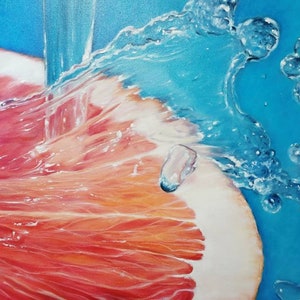 May include: A close-up of a grapefruit being washed with water. The water is splashing and creating bubbles. The grapefruit is pink and has a white pith.