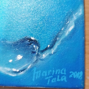 May include: A blue and white abstract painting with a signature in the bottom right corner that reads "Marina Tala 2018".