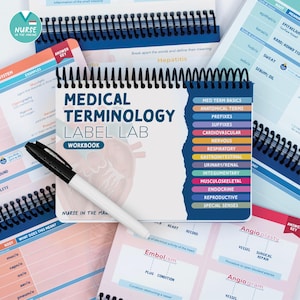 May include: A spiral-bound Medical Terminology Label Lab workbook with a black marker resting on the cover. The cover features the title, a list of medical categories, and a faint anatomical heart illustration in the background.
