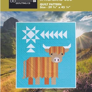 May include: A quilt pattern titled "Cattle Call A Highland Coo" with a turquoise background and a geometric design of a Highland cow. The quilt measures 39 3/4" x 45 1/4". The image includes the text "Art East Quilting Co."