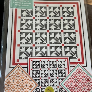 May include: A quilt pattern titled "Black Dahlia" with a repeating black and white floral design. The pattern includes red and black borders and the text "NO TEMPLATES! 2 fabrics & a dozen design options!" is visible.