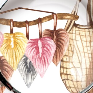 May include: A watercolour illustration of a wooden branch with five hanging leaves. The leaves are in shades of pink, yellow, brown, and grey. The branch is hanging from a woven basket.