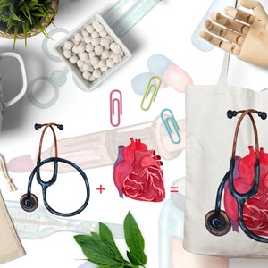 May include: A white tote bag with a watercolor illustration of a red heart and a black stethoscope. The heart is in the center of the bag and the stethoscope is wrapped around it. The bag is on a white background.