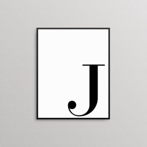 May include: A black and white printable wall art print featuring the letter J in a bold, modern font.