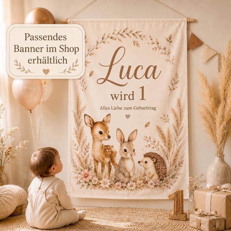 May include: A cream-colored fabric wall banner featuring the name Luca, the text wird 1, and Alles Liebe zum Geburtstag. The design includes illustrations of a fawn, a rabbit, and a hedgehog surrounded by pampas grass, leaves, and flowers.