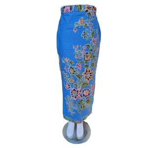 May include: A blue skirt with a floral print. The skirt is on a white mannequin.