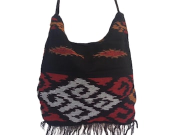 May include: Black and red woven shoulder bag with a fringe trim. The bag has a geometric pattern with orange accents.