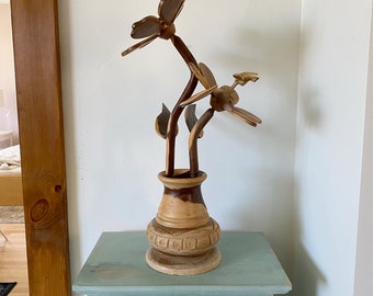 Wooden sculpture of a flower pot with 2 big flowers and a colibri, big handmade flower statue