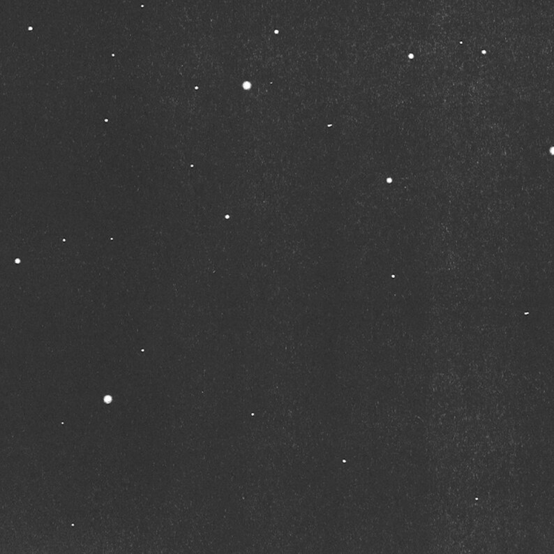 May include: A monochrome image showing a night sky with many bright, white stars of different sizes. The stars are spread across a dark, textured background, forming a celestial pattern.