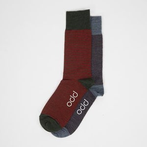 May include: A pair of socks with a red and white striped pattern, a green top, and a blue bottom. The socks have the word "odd" written on the bottom.