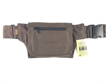 May include: A brown canvas fanny pack with a zippered pocket and a black buckle. The fanny pack has a small tag attached with the text "Crous, Free Gift Of A... www.crous.com.au The Direct Source... crous.com.au".