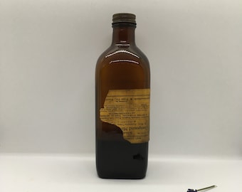May include: A brown glass bottle with a label that reads "Compound Mix Mist. Hydrastis Comp. PERCENT ALC. A BITTER STOMACHIC, TOPICAL ASTRINGENT VASOCONSTRICTOR Schlotterbeck & Fox Co., Portland, OR."