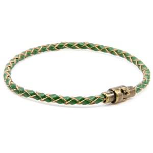 May include: A green leather bracelet with a braided design and a brass magnetic clasp.