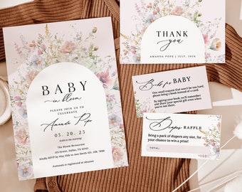 May include: A floral baby shower invitation with a watercolor design. The invitation features a floral arch with the text "Baby in Bloom" and the date "05.20.23".