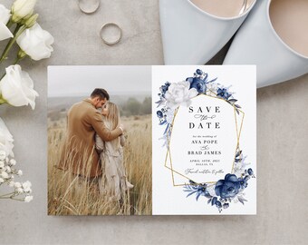 May include: Save the Date wedding invitation with a blue and white floral design and a gold geometric frame. The invitation features a photo of a couple in a field and the text "Save the Date" for the wedding of Ava Pope and Brad James on April 15th, 2021 in Dallas, TX.