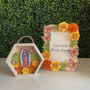 May include: Two wooden picture frames decorated with paper flowers and butterflies. The larger frame is 4x6 inches and says "Photo frame". The smaller frame is hexagonal and features a religious image.