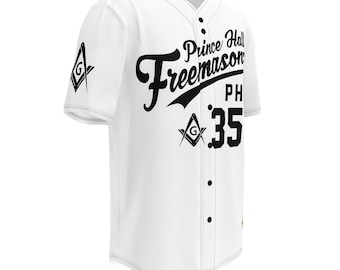 May include: White baseball jersey with black text and graphics. The jersey features the words "Prince Hall Freemason" and the number "35". A Masonic symbol is on the sleeve and front. The jersey has a button-up front and short sleeves.