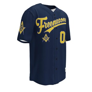 May include: A navy blue baseball jersey featuring the word "Freemasons" in yellow script. The number "0" is displayed on the front, and a Masonic symbol is on the sleeve. The jersey has a button-up front.