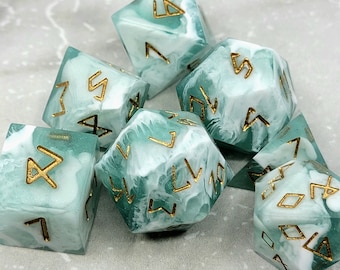 May include: Set of six teal and white dice with gold runes. The dice are made of a translucent material with a swirling pattern.