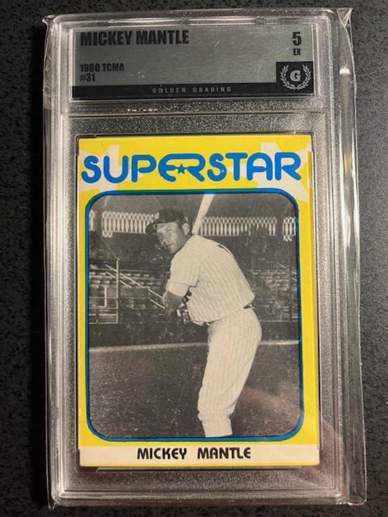 Op de afbeelding: Een vintage Mickey Mantle honkbalkaart in een beschermende houder. De kaart toont een zwart-wit afbeelding van Mantle in zijn honkbaluniform, met het woord "SUPERSTAR" in blauw op een gele achtergrond. De kaart is beoordeeld met "5 EX" door Golden Grading.