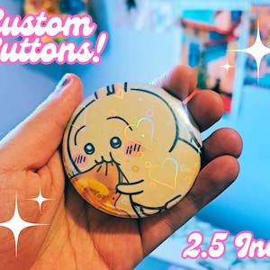 May include: A 2.5 inch custom button featuring a cartoon illustration of a yellow character with pink cheeks and hearts. The character is holding a piece of food. The button has a holographic finish.