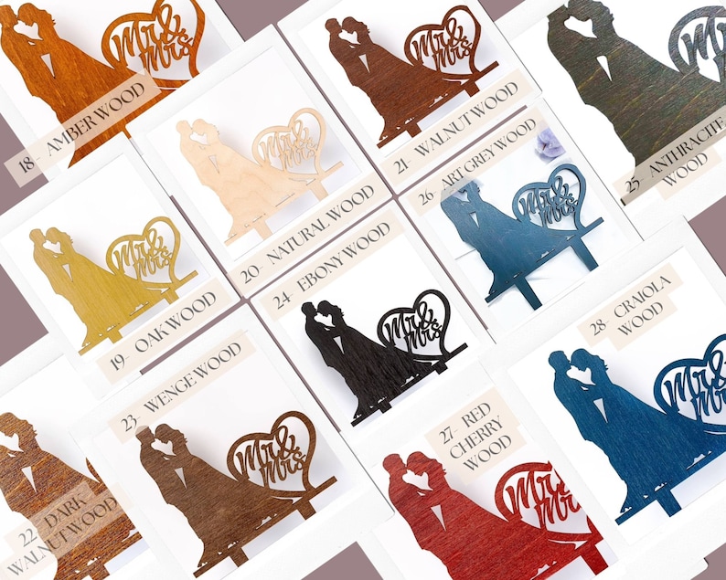May include: A collection of wooden cake toppers featuring a silhouette of a couple kissing next to a heart shape with the text Mr & Mrs. The toppers are available in various finishes including amber, walnut, anthracite, natural, oak, ebony, wenge, red cherry, and craiola wood.