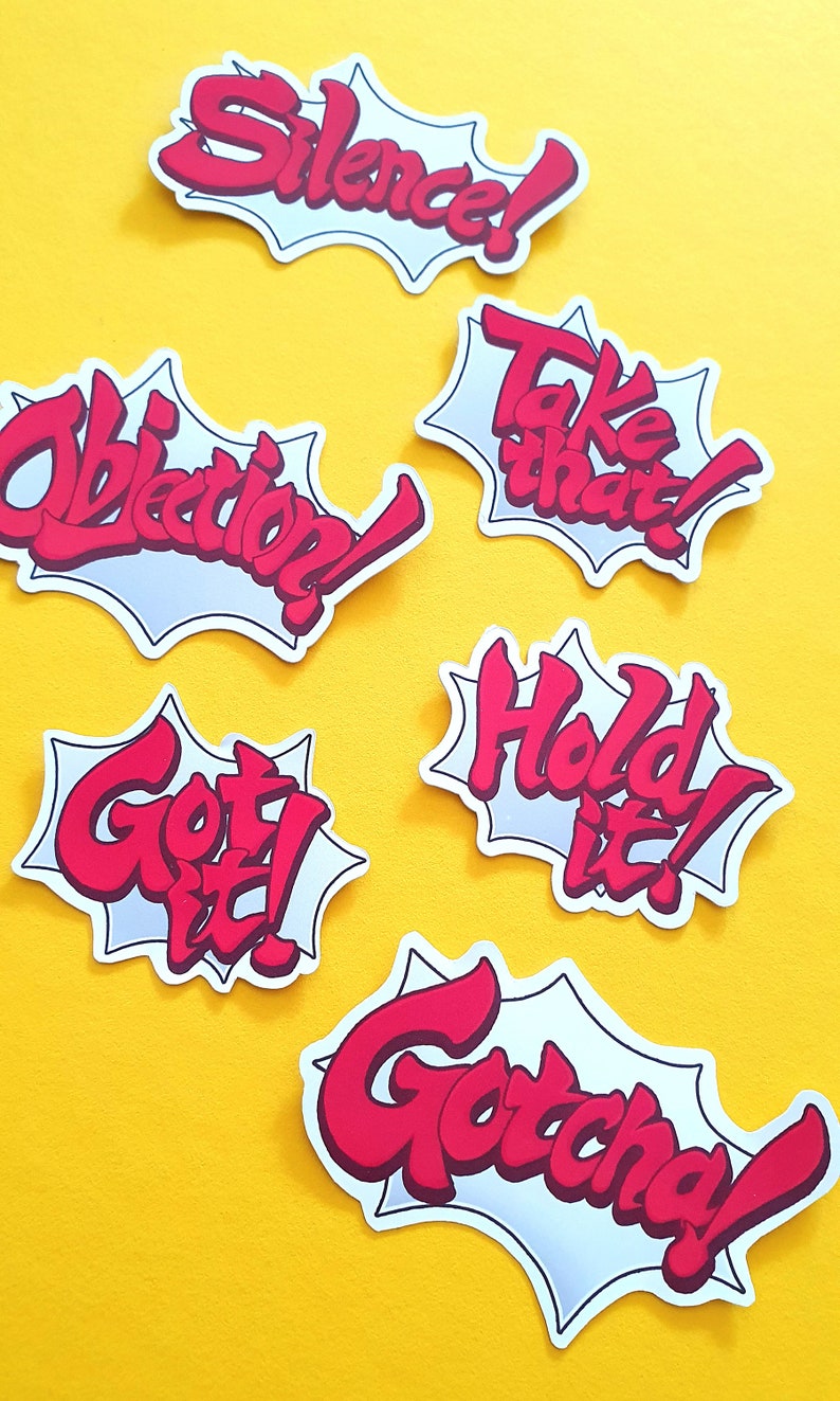 May include: Six red and white speech bubble stickers with different phrases. The phrases are "Silence!" "Take that!" "Objection!" "Hold it!" "Got it!" and "Gotcha!"