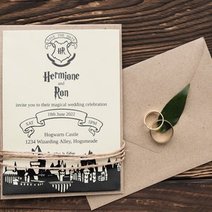 May include: A save the date wedding invitation with a Harry Potter theme. The invitation features a crest with the initials "HR" and the text "Hermione and Ron". The invitation also includes the date "18th June 2022" and the location "Hogwarts Castle, 1234 Wizarding Alley, Hogsmeade".