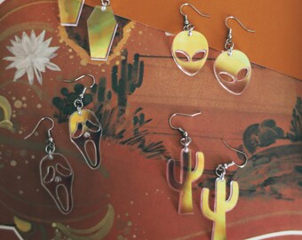 Handcrafted laser cut small clear iridescent rainbow earrings alien / cactus / coffin / scream mask