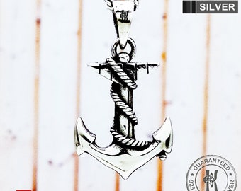 May include: A silver anchor pendant necklace with a rope design. The pendant is on a silver chain. The necklace is labeled "KIM N KIM SILVER" and "GUARANTEED 925 STERLING SILVER".