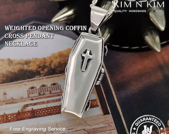 May include: Silver coffin-shaped pendant necklace with a cross on the front. The pendant is on a silver chain and is hanging from a black leather bracelet with silver spikes. The text "KIM IN KIM QUALITY HANDMADE SILVER" is visible in the background. The text "GUARANTEED 925 STERLING SILVER" is visible in the bottom right corner of the image.