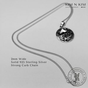 May include: A silver chain necklace with a 2mm wide curb chain and a round pendant with a detailed design. The pendant is made of solid 925 sterling silver. The chain and pendant are guaranteed to be sterling silver.